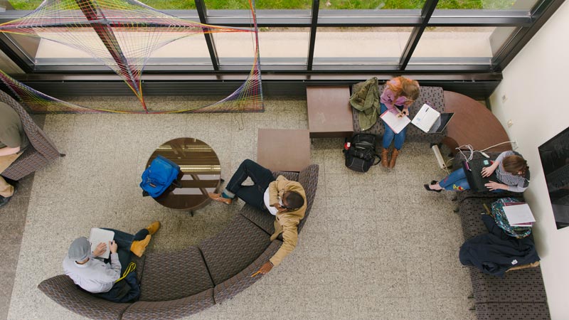 Overhead view of people sitting on office furniture