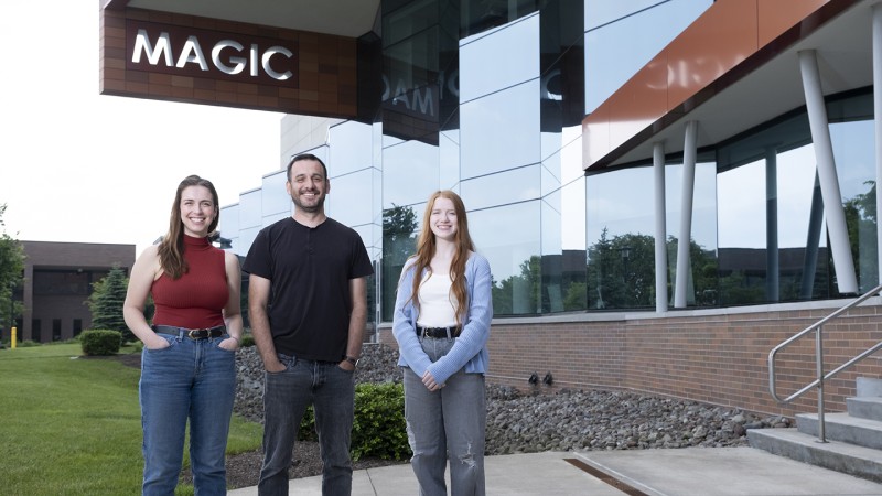 Animation faculty and students pose for a portrait outside MAGIC Spell Studios.