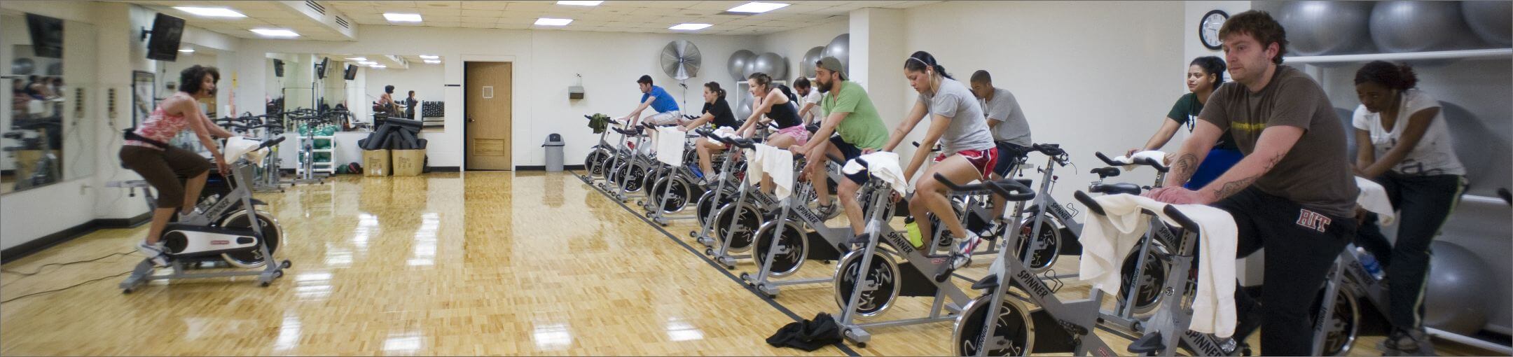 Students in an indoor cycling class.