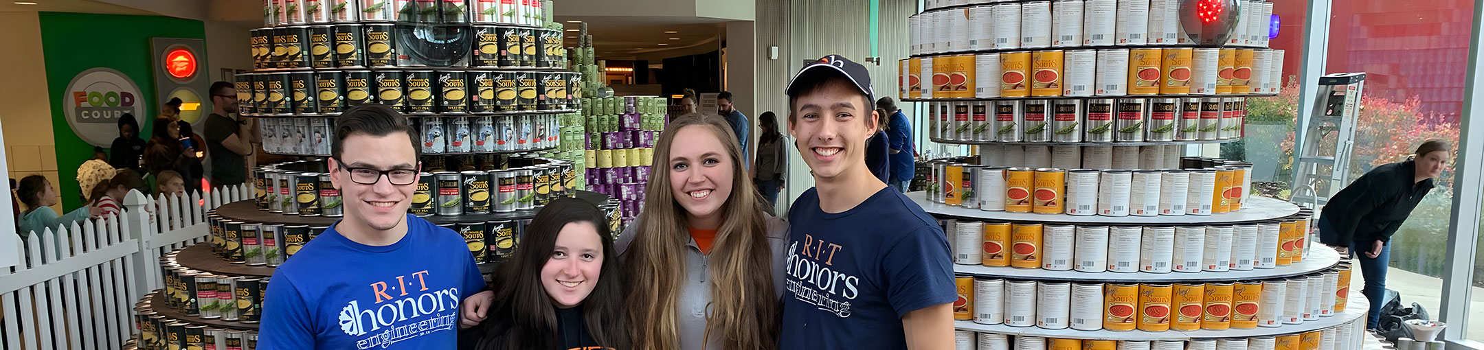 image of four Honors students at a service event