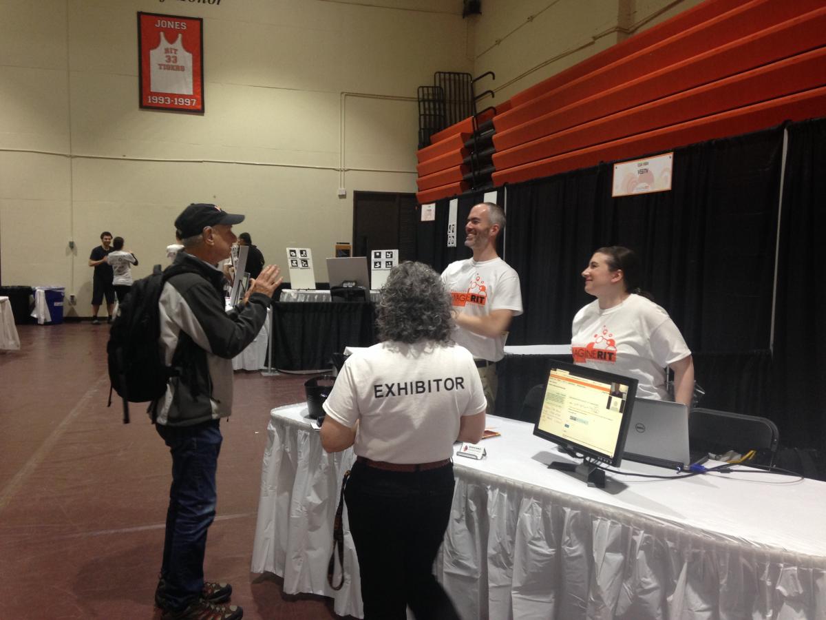 Two DHHVAC staff talking to Imagine RIT guest.