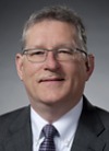 Headshot of Jeff  McCaw, glasses, grey hair, suit and tie