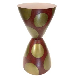 Dark brown hourglass shaped table with large metallic gold spots.