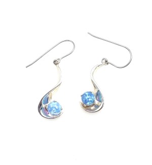 A pair of wave shaped silver earrings with a sparkly blue gemstone perched at the bottom.