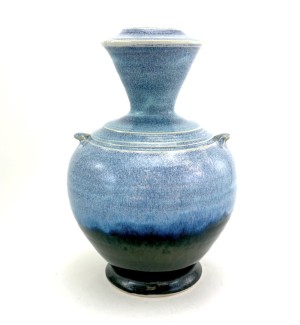 a ceramic bottle shaped vase with a sky blue glaze.