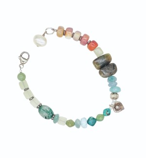 a bracelet with an asymmetrical curation of beads with colors reminiscent of fresh spring hues. 