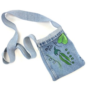 a handsewn shoulder bag of blue jean material with a painted illustration of a green pea pod.