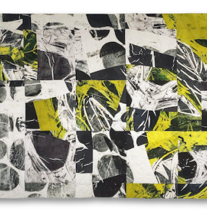 a painterly fabric quilt with an overriding grid that displays areas of bold black circular forms on white and grey backgrounds highlighted with acid green forms.