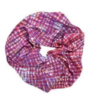 a multi color silk scarf with pink, purple and light blue cross cross design arranged in a circle. 