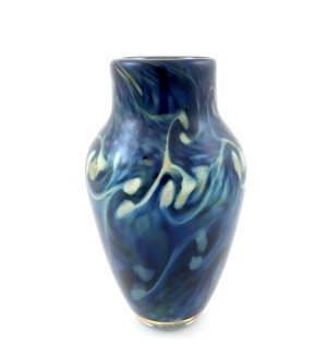 a handblown glass vase with a narrow opening, a shouldered top that narrows to the base with a deep blue and lighter blue swirled pattern.