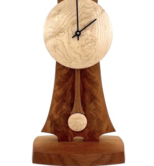 a handcrafted tall mantle clock with a round face and two hands made of dark grained woods