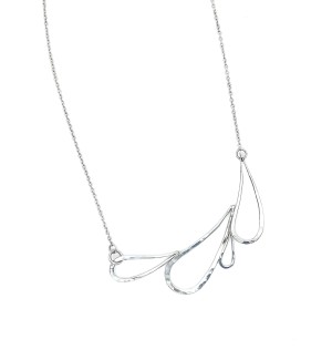  A handcrafted Sterling silver necklace with a series of droplet shapes joined to make a horizontal design with a subtle hammered surface.