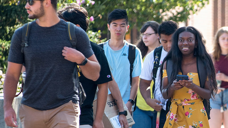 Students walking down the Quarter Mile walkway on campus