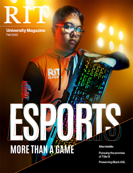 cover of fall 2022 University Magazine featuring an esports student holding a computer keyboard.