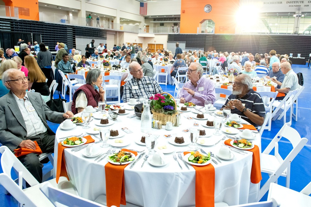 retirees seated at large round banquet tables.