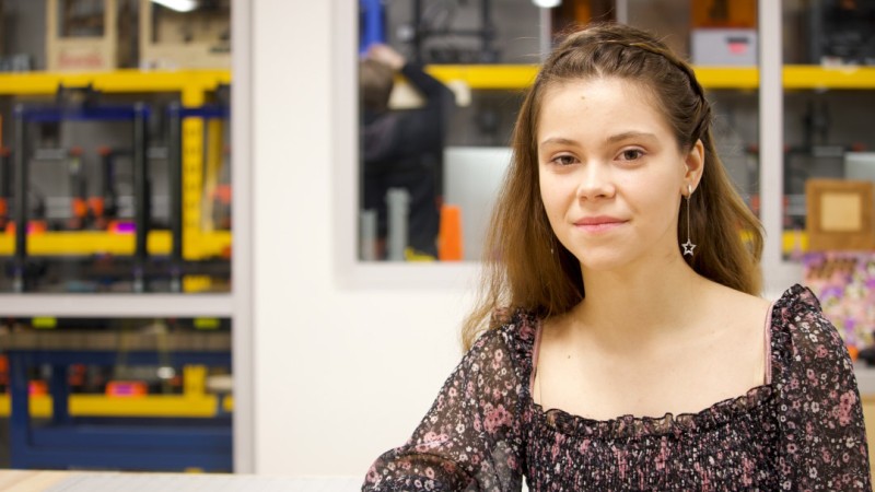 RIT MS in Artificial Intelligence Student Diana Velychko posing for portrait in front of blurred equipment