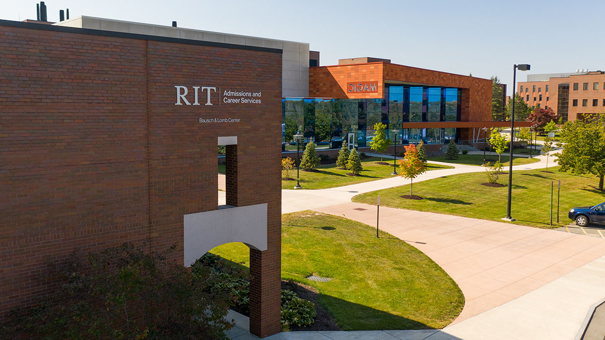 The R I T Admissions and Career Services building with modern architecture and green surroundings.