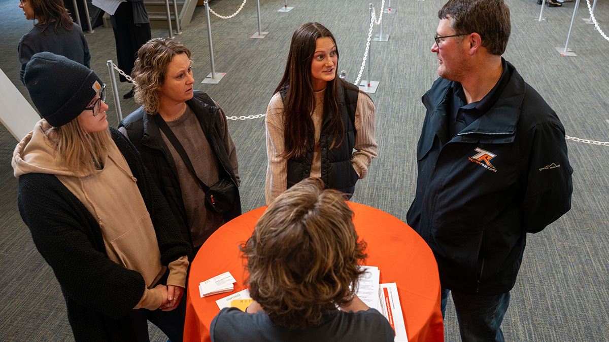 Overhead photo of parents and a student talking to an R I T financial aid advisor