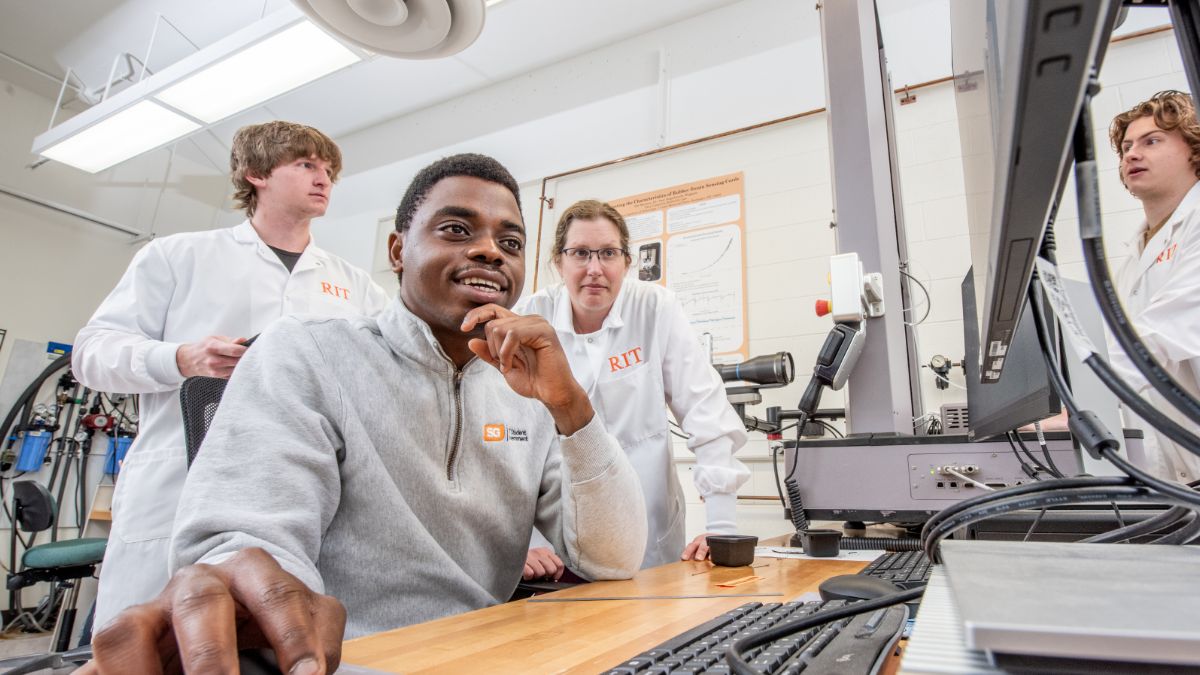 researchers collaborating on a computer.