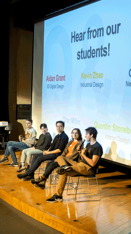 a panel of students talking in front of a screen