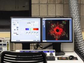 Two monitors in a lab, showing results of a test.