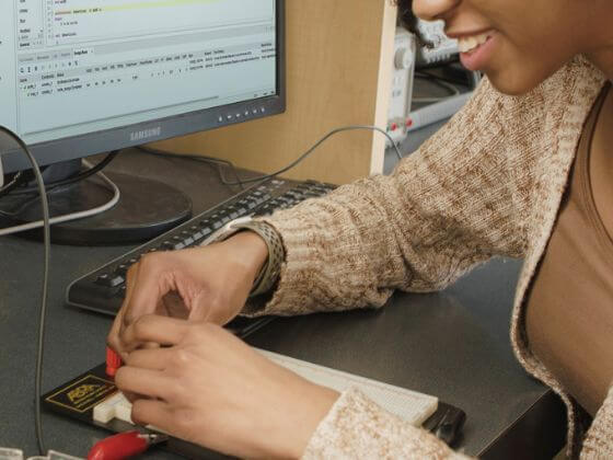 A closeup of a person working with a breakout board.