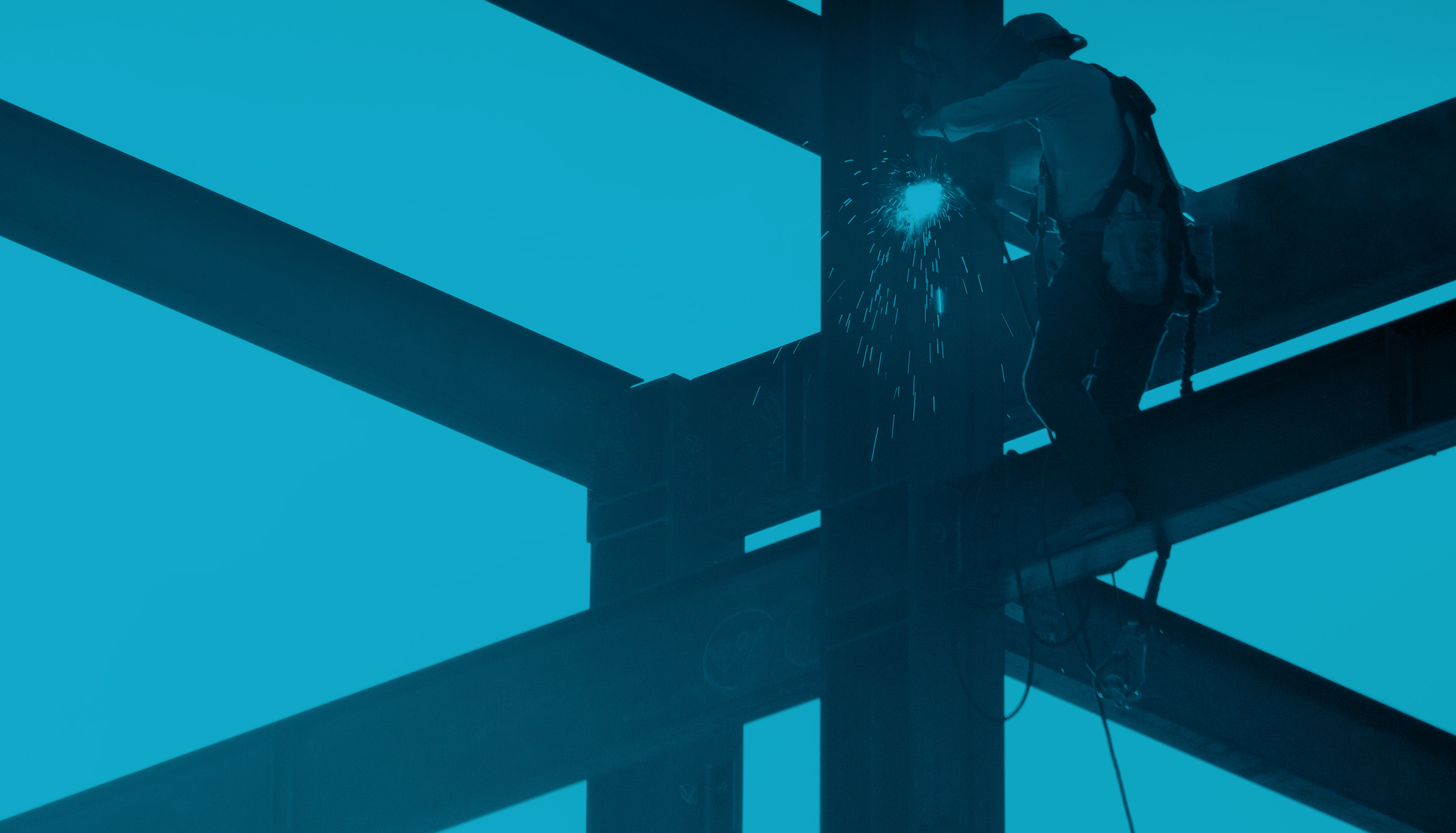Construction worker on steal support beam welding. With a sky blue tint over the entire image.