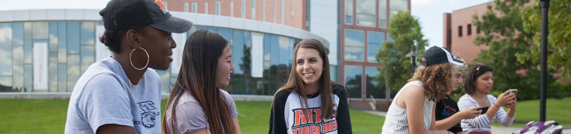 Students talking outside of the Simone Center building.