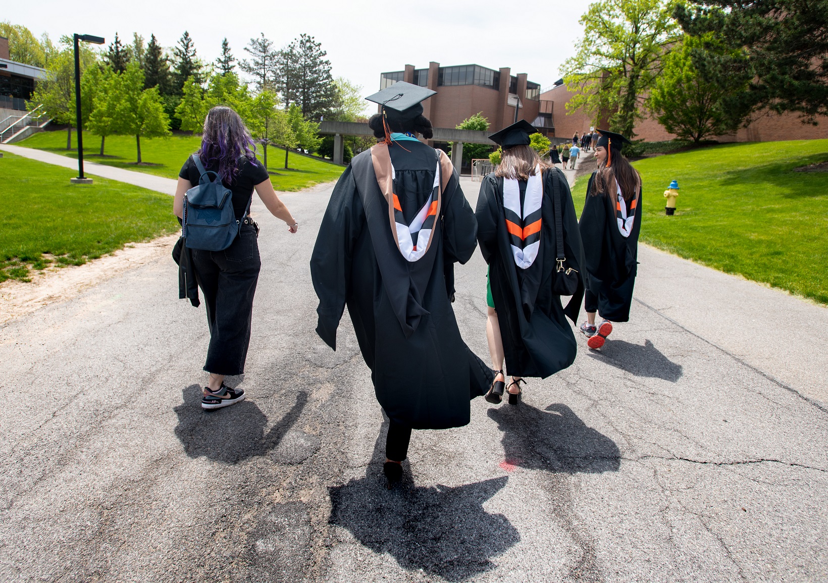 a group of students walking in their caps and gowns