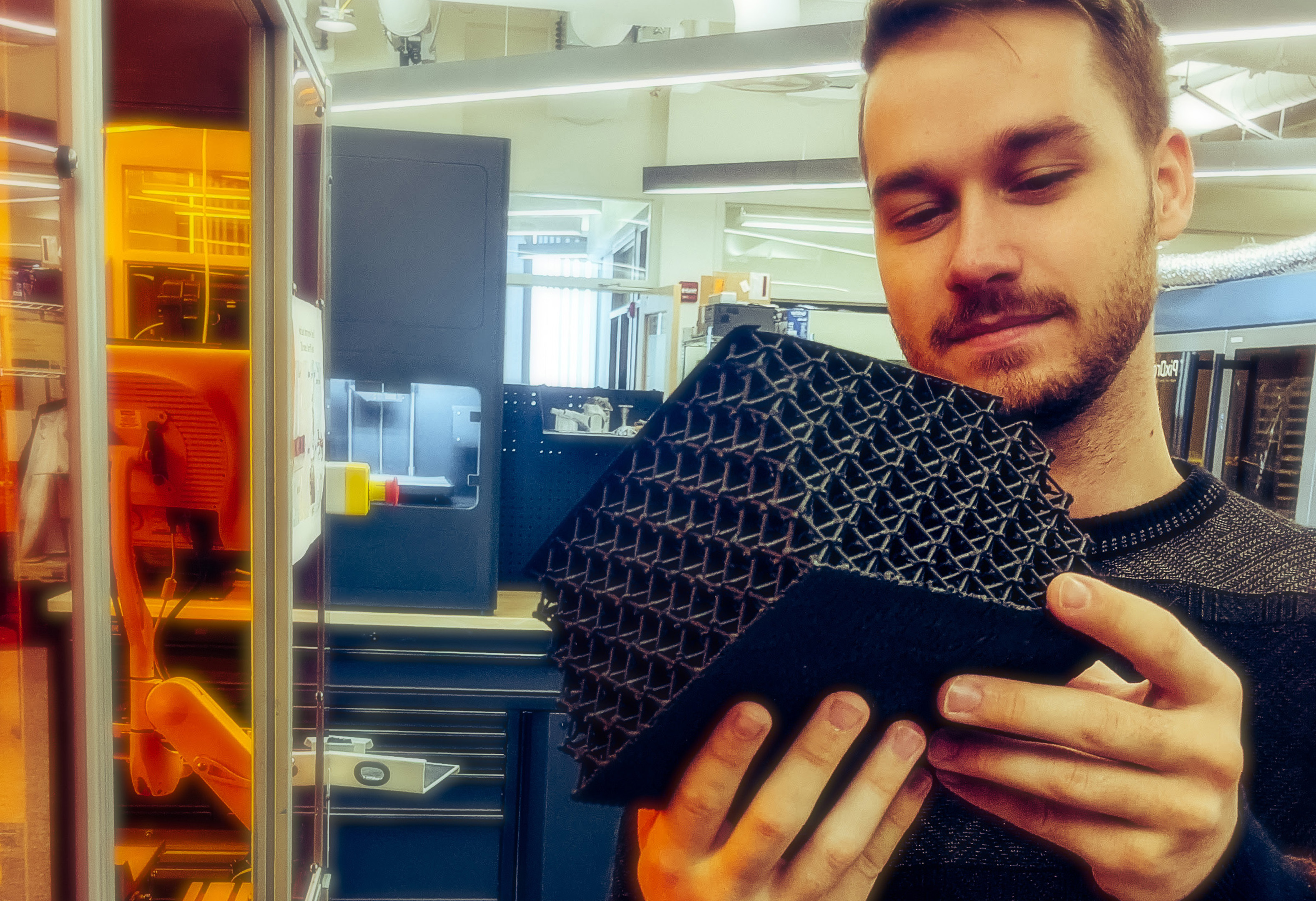 Student holding a 3D printed lattice sample