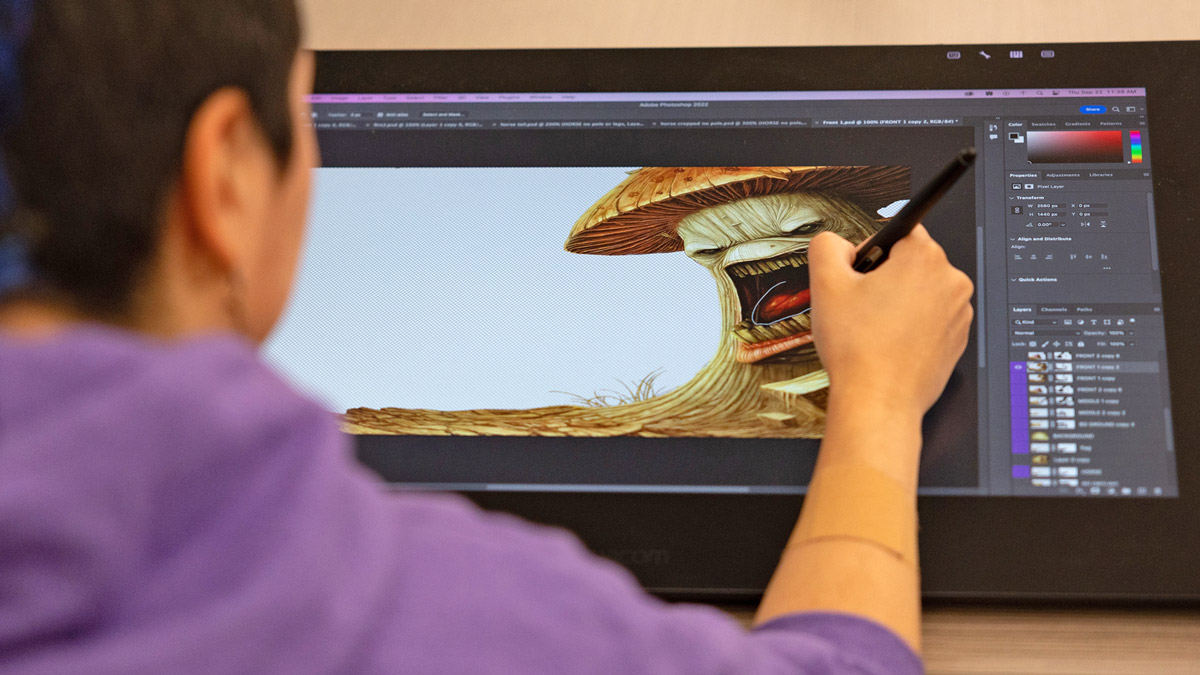 A student working on an illustration of a mushroom on a touch screen.