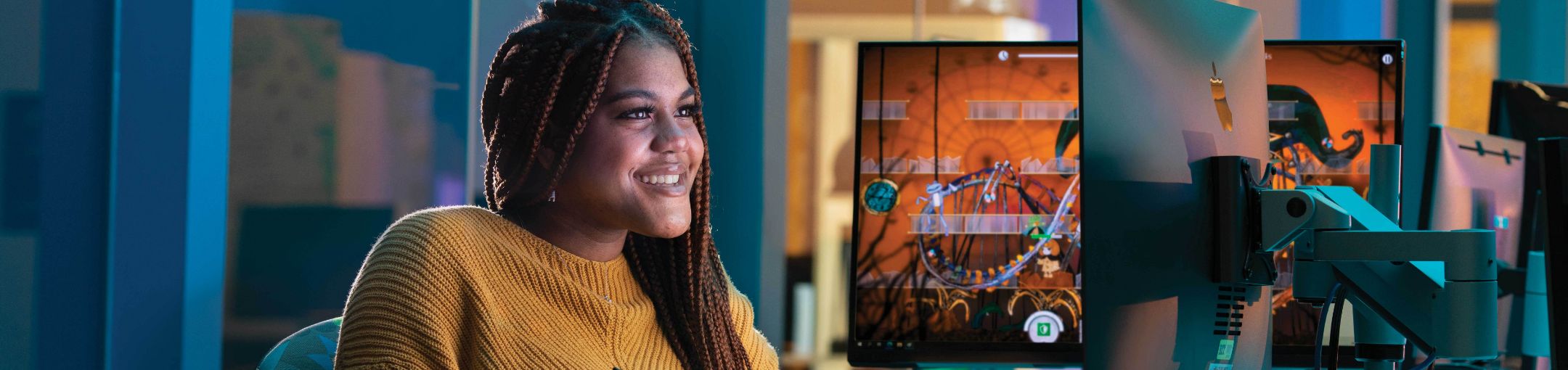 Woman sitting at a computer screen.