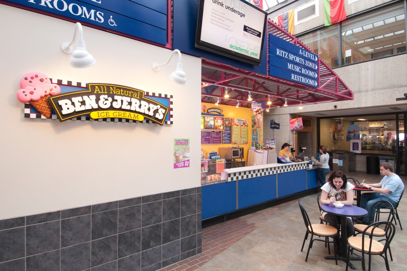 wide angle view of the counter with students in the forground ordering ice cream