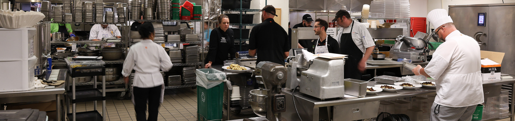 chefs moving in a kitchen