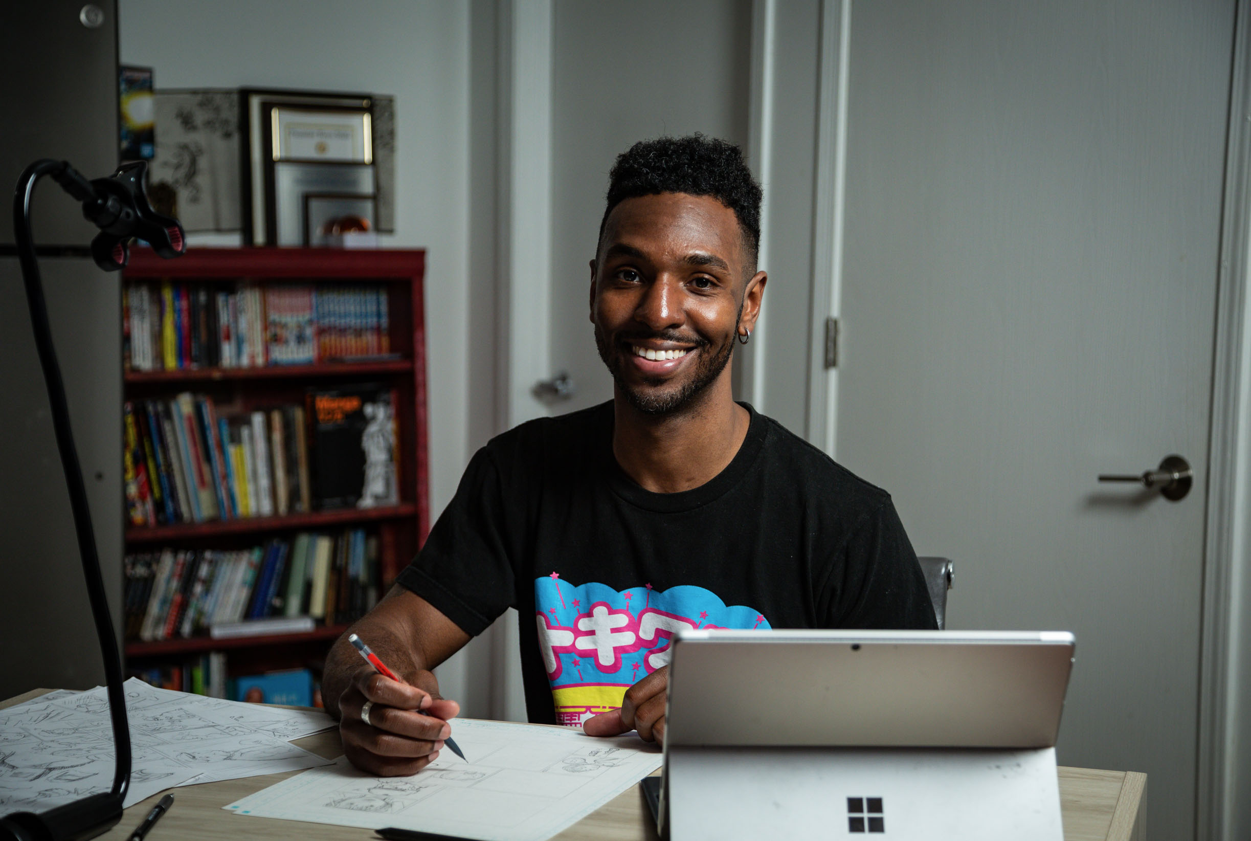 man sitting in front of desk smiling