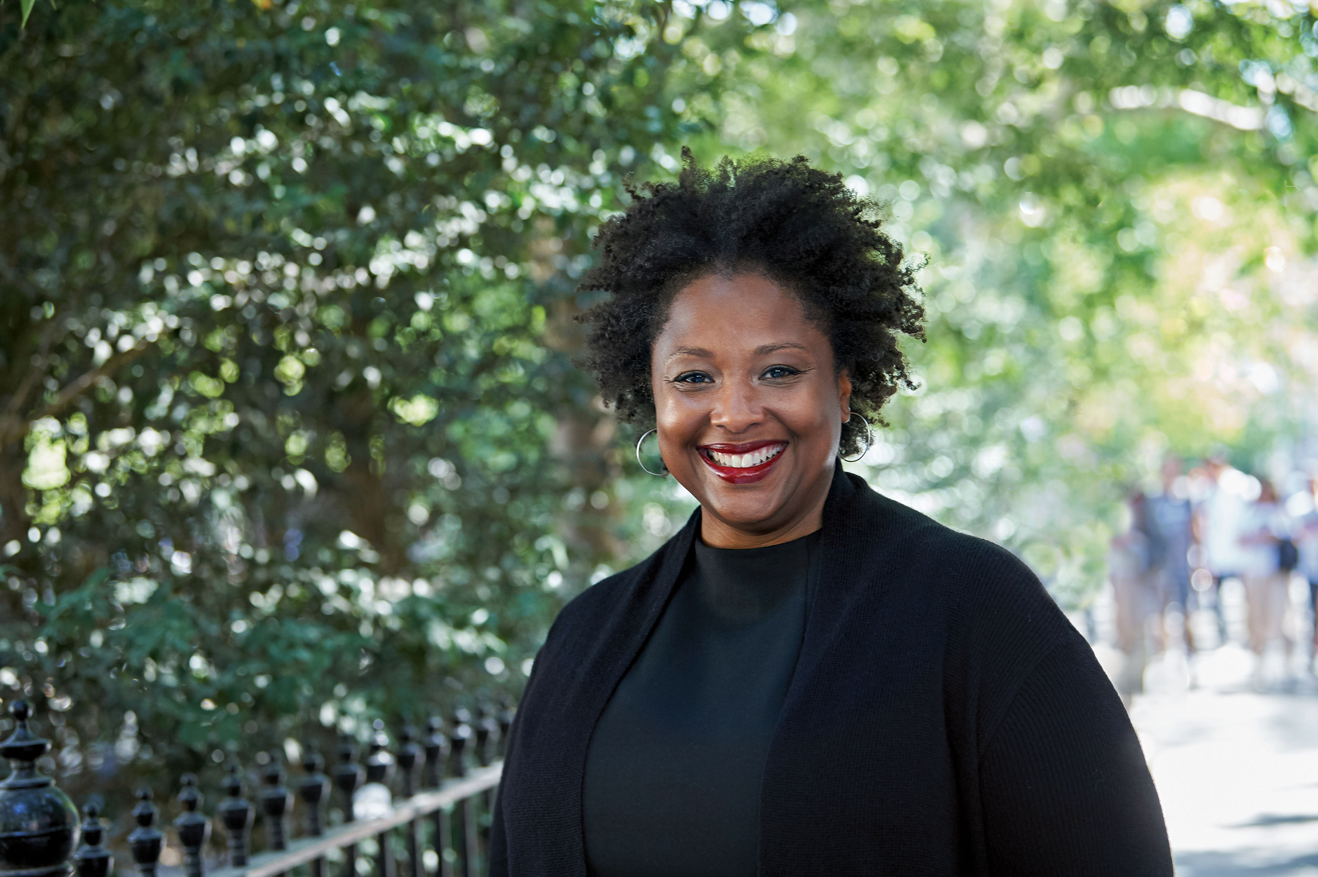 black woman outside with trees in the background