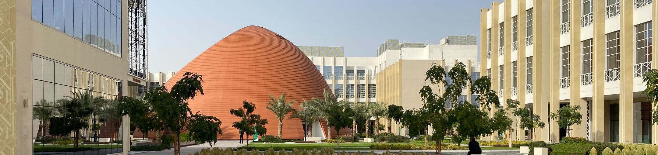 Campus with a brown, round building in the middle