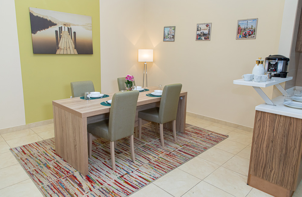 Sample view of a single person living space with a dinning room table and chairs