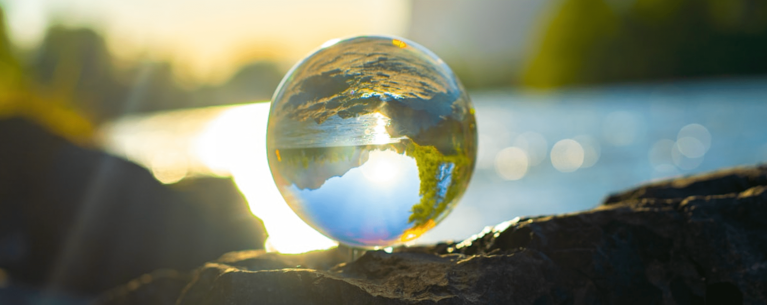 A clear marble showing a shot of a river and mountains