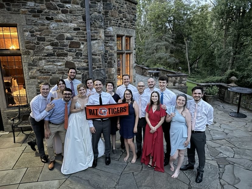 Michael and Sara surrounded by RIT alumni and Family at their wedding