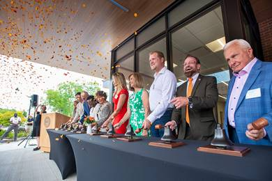 From right to left, Philip Saunders;  Harry Bronson; Chance Wright, Susan Holliday, Dinah Gueldenpfennig Weisberg, and Brigitte Gueldenpfennig; Taliah Clark; David Munson; Daniel Lootens; and Jacqueline Mozrall ring the opening bell.