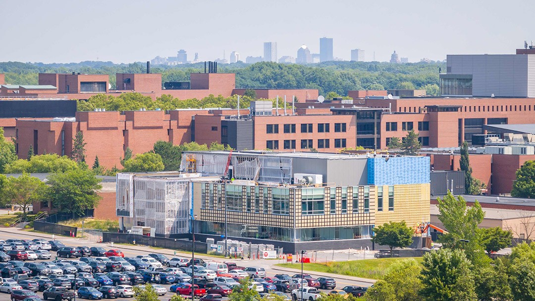 Against the backdrop of campus and the city of Rochester, the research building (foreground) will become one of RIT’s newest facilities with expected occupancy in spring ’25.