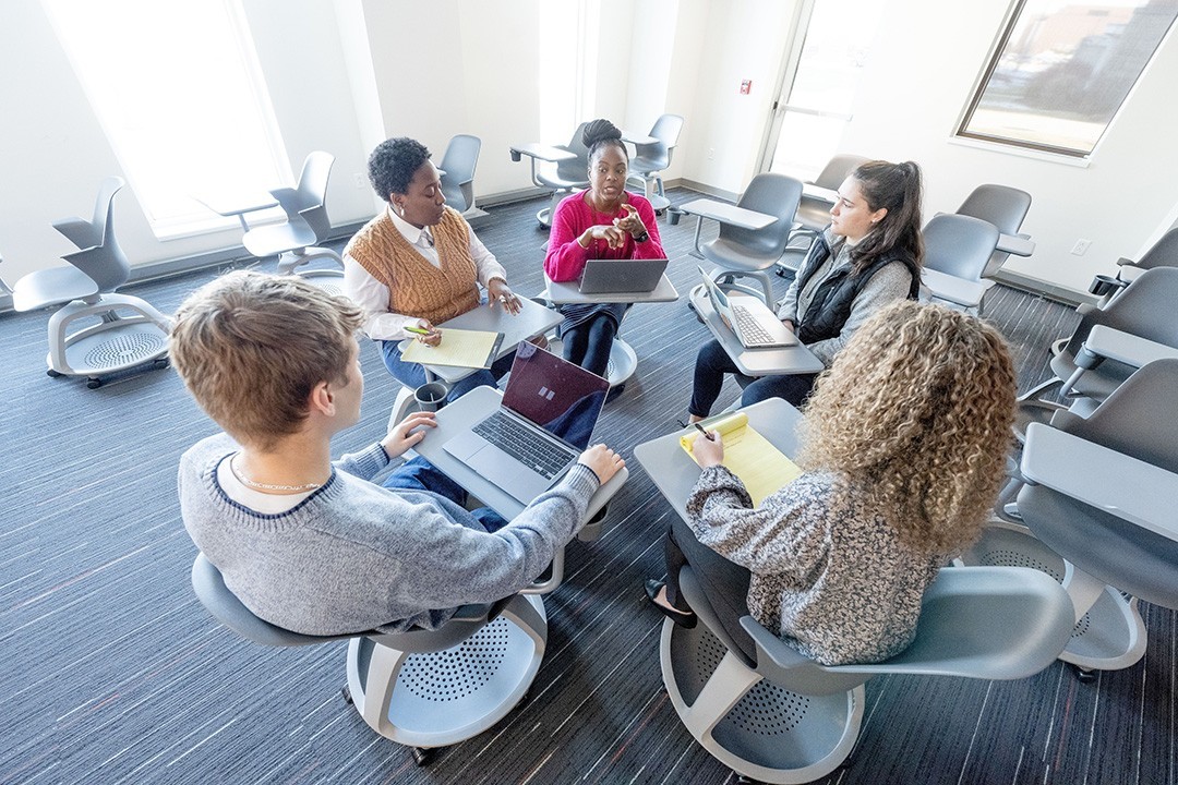 People sitting together in a round table discusing something