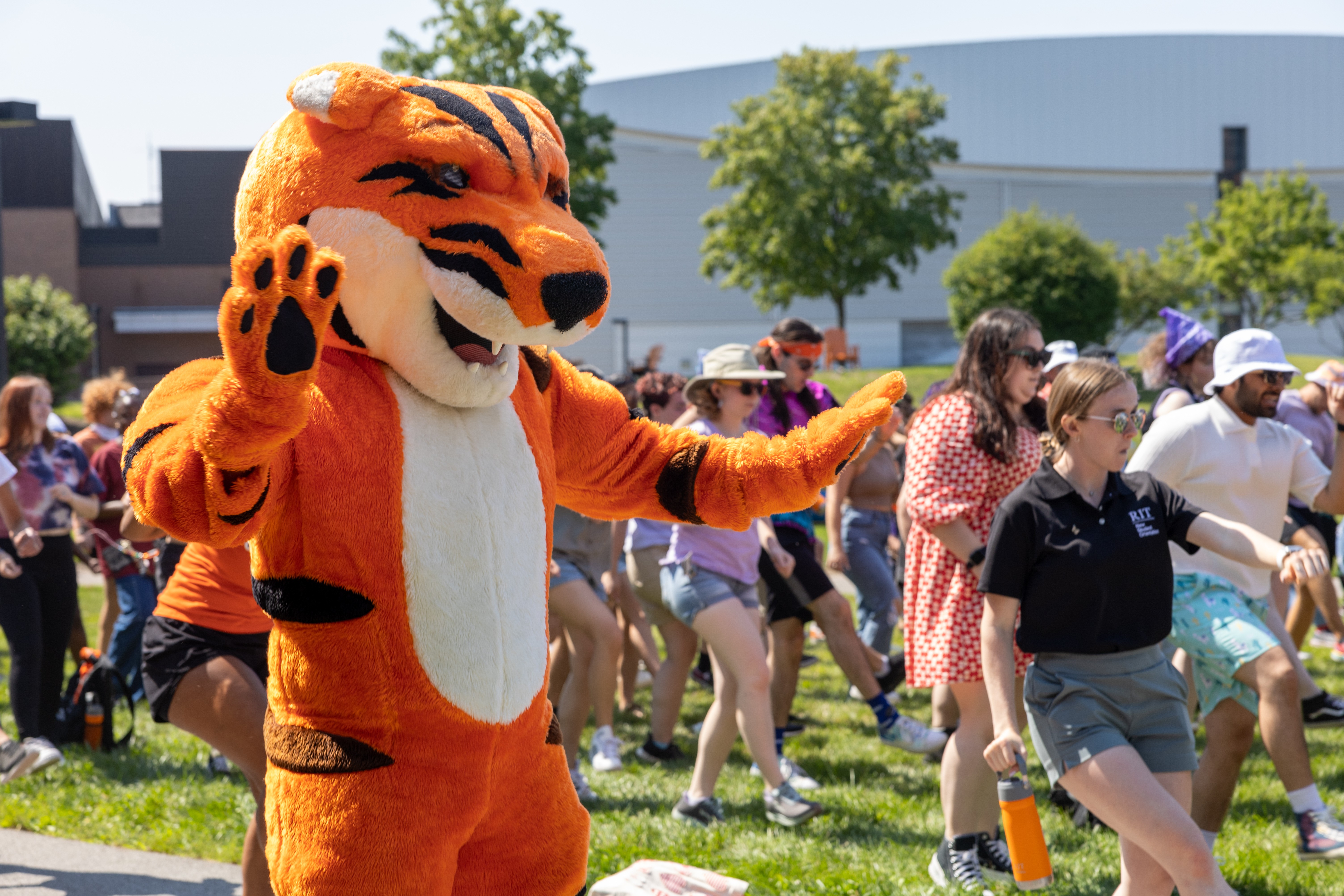 Ritchie dancing in the lawn with RIT students