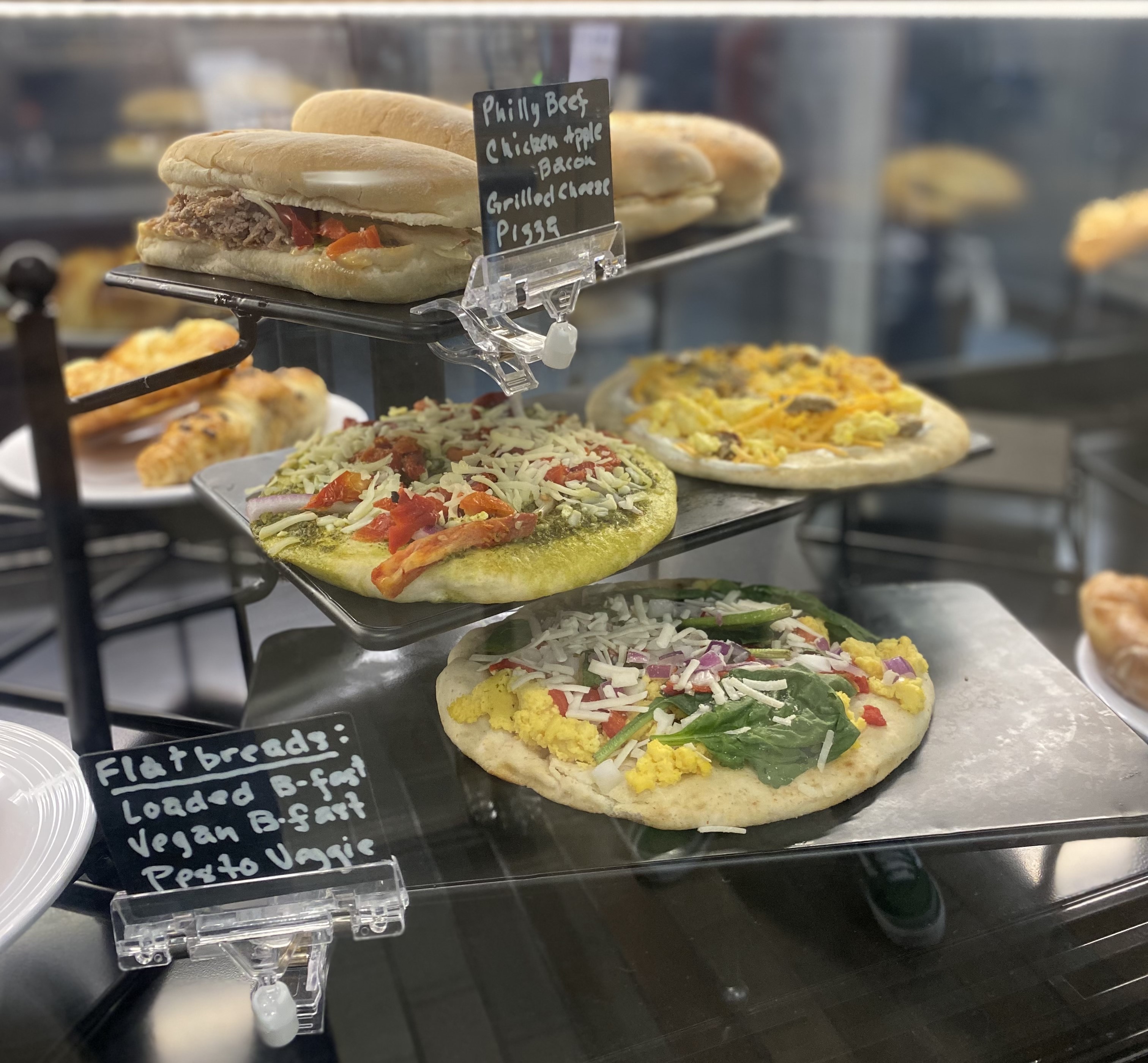 Ready-to-eat flatbread pizzas are displayed at the Beanz food counter.