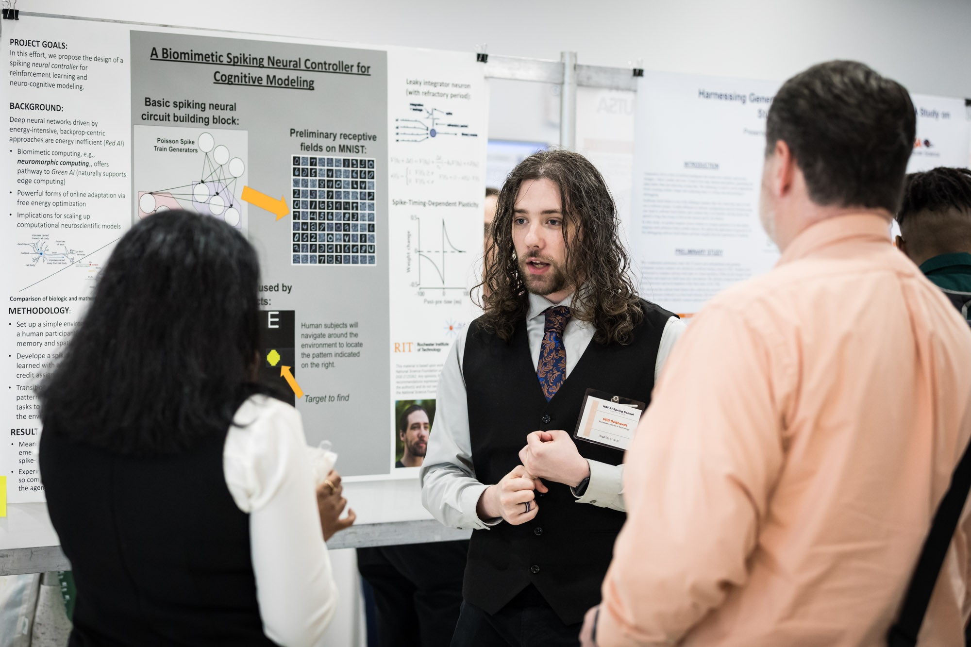Will Gebhardt speaking with visitors about his poster