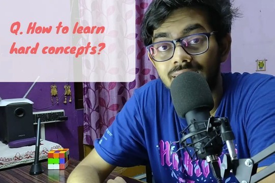 A man at a desk, engaging in a video tutorial, with an overlay text questioning how to learn hard concepts.