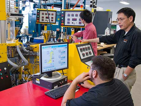 Small group of people calibrating heavy machinery