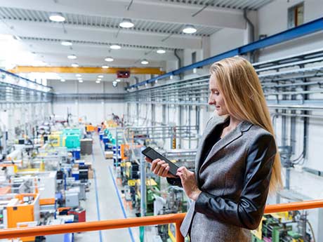 Manager overlooking a production room from a balcony