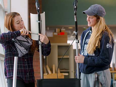 Two students setting up equipment for an experiment